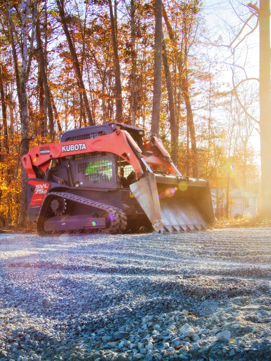 Compact loader working on a concrete project in Old Bridge NJ in autumn