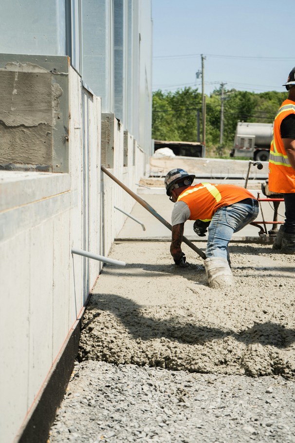 Construction worker setting up concrete formwork on a job site in Old Bridge NJ